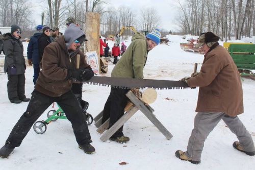 Chad and Glen Matson show how it used to be done in the days before chainsaws as Chucky Millard keeps their log steady at the Matson Family Fun Day at the Farm Sunday during the 14th annual Frontenac Heritage Festival. Photo/Craig Bakay